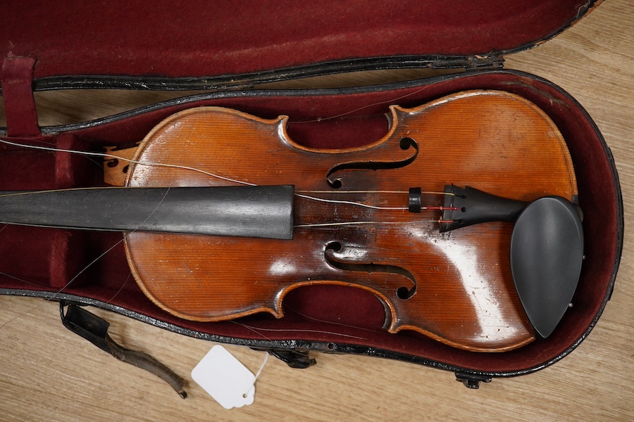 Two cased violins; one French 19th century bearing a hand written label for Francesco Werentle 1746, body length 35.5cm, the other an early 20th century violin, body length 35cm. Condition - poor.